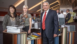 Cox Architecture architect Christina Cho and graduate Jenna Campbell - winners of the Architext pop-up bookshop competition - with BlueScope national business development manager, John Rosette, at the 2014 National Architecture Conference in Perth.